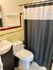 Charming bathroom with vintage tile accents, sleek fixtures, and a cozy shower area for a classic touch.