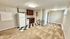 Bright and inviting living area featuring an open kitchen with classic checkered flooring and modern cabinetry.