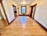 Charming room with polished hardwood floors, elegant wood trim, and built-in shelving, offering a cozy and inviting atmosphere.