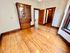 Inviting room with polished hardwood floors, vintage wooden cabinet, and warm natural light.