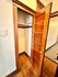 Charming wooden closet with vintage-style door, offering ample storage space and warm wood tones.