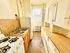 Charming kitchen with vintage flair featuring a cozy countertop, gas stove, and ample cabinetry filled with character.