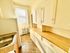 Bright, cozy kitchen with ample cabinet storage, sleek countertops, and a window bringing in natural light.