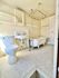 Charming vintage-style bathroom with a classic clawfoot tub, hexagonal tile flooring, and elegant fixtures.