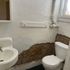 Cozy bathroom with vintage charm, featuring a pedestal sink and exposed brick accent wall.