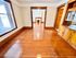 Inviting apartment space featuring polished hardwood floors, bright natural light, and a charming built-in cabinet.