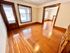Charming apartment featuring polished hardwood floors, natural light from large windows, and a warm, inviting atmosphere.