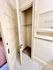 Charming closet space with elegant white door and classic tiled flooring, perfect for stylish storage solutions.