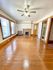 Bright and spacious living room with polished hardwood floors, classic fireplace, and ceiling fan accentuating cozy ambience.