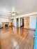 Charming room featuring polished hardwood floors, a classic fireplace, and rich wooden doors, offering a blend of comfort and elegance.