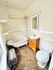 Charming bathroom with vintage clawfoot tub, elegant tile flooring, and bright natural lighting.