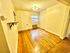 Charming room with warm wooden floors, ambient lighting, and a cozy window view.