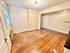 Charming apartment space featuring elegant hardwood floors, abundant natural light, and a stylish ceiling fixture.