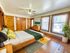 Inviting bedroom with warm wood accents, large windows, and modern decor for a cozy retreat.
