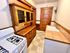 Charming kitchen with vintage wood cabinetry, modern white stove, and tiled countertops creating a cozy and inviting space.
