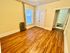 Inviting room with warm hardwood floors, ample closet space, and natural light through a large window.