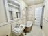 Charming vintage bathroom with a classic clawfoot tub, unique wall-mounted sink, and vintage cabinetry for a cozy and inviting atmosphere.