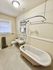 Charming vintage bathroom featuring a classic clawfoot bathtub and elegant hexagonal tile flooring.