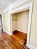 Spacious closet with wooden floors and classic trim, adding charm to any living space.