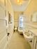Charming bathroom with vintage claw-foot tub, classic sink, and quaint fixtures, exuding a cozy and inviting atmosphere.