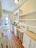 Charming vintage kitchen with bright natural light, classic farmhouse sink, and elegant wood flooring.