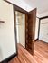 Charming closet space in an apartment with elegant hardwood floors and classic wooden doors.
