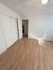 Charming room with elegant wood flooring, bright natural light, and ample closet space, perfect for a cozy retreat.