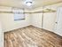 Bright, spacious room with elegant hardwood floors and subtle lighting, perfect for a cozy haven or creative workspace.