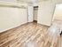 Bright and inviting room featuring elegant wood flooring, neutral walls, and ample closet space.