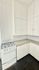 Charming kitchen with classic white cabinetry, modern gas stove, and sleek tile backsplash creating a bright and inviting space.