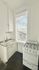 Charming kitchen with bright window, sleek sink, and vintage gas stove, perfect for cozy cooking.