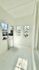 Bright and airy room featuring large windows with abundant natural light and fresh white walls.