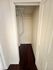 Compact storage space with elegant wooden flooring, highlighting ample room for organization and utility.