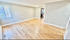 Bright and spacious living room with elegant hardwood floors and ample natural light.