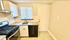 Modern kitchen featuring sleek granite countertops, stainless steel appliances, and a bright window accentuating the space.