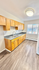 Bright and welcoming kitchen with modern wood cabinetry, sleek countertops, and large window for natural light.