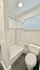 Modern bathroom featuring a sleek bathtub, elegant tile walls, and soft natural lighting.