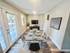 Bright dining area with modern table setting, large windows, and elegant decor, perfect for entertaining.
