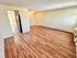 Inviting open-concept living space with beautiful wood flooring and ample natural light.