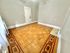 Elegant room with intricate hardwood flooring and classic white door, perfect for a sophisticated living space.