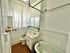 Charming bathroom with vintage clawfoot tub, elegant fixtures, and bright natural light.