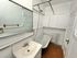 Charming vintage bathroom featuring a classic clawfoot tub, elegant wood flooring, and ample cabinet storage.