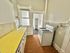 Charming cozy kitchen with bright countertops, classic gas stove, and vintage white cabinetry.