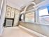 Bright and airy room with unique arches, ample built-in storage, and large windows offering scenic views.