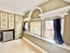 Charming room with vintage architectural details, large windows, and elegant molding, offering abundant natural light and character.