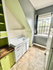 Charming kitchen nook with bright natural light, featuring vintage farmhouse sink and sleek cabinetry.