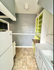 Charming kitchen with fresh modern design, featuring lime green accents, ample storage, and a cozy layout.