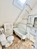 Charming bathroom with a freestanding clawfoot tub, skylight, and elegant sink, offering a cozy and inviting atmosphere.