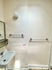 Bright bathroom with modern sink, sleek towel racks, and minimalist mirror design.