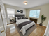 Cozy and inviting bedroom with elegant decor, featuring a plush bed, chic side tables, and abundant natural light.